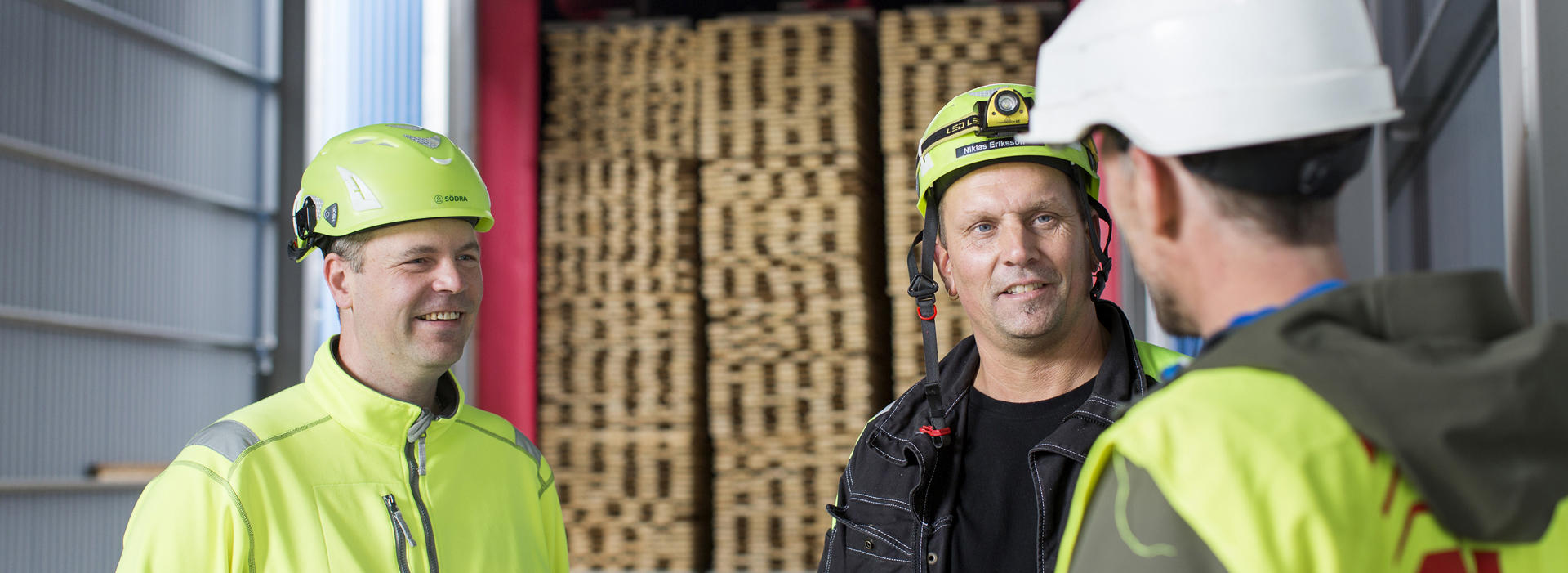 Three Valutec workers standing and talking.